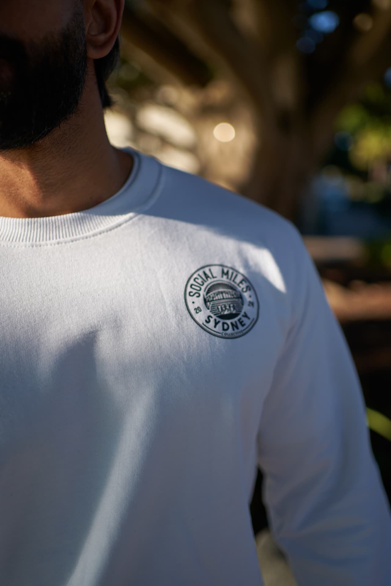 White Social Miles Sydney crew with the circular club crest on the chest.