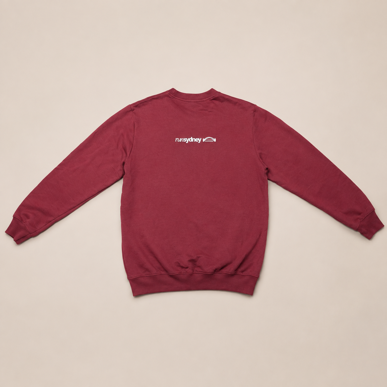 Back view of the maroon Social Miles Sydney runSydney crewneck pullover with the white runSydney bridge mark across the upper back.
