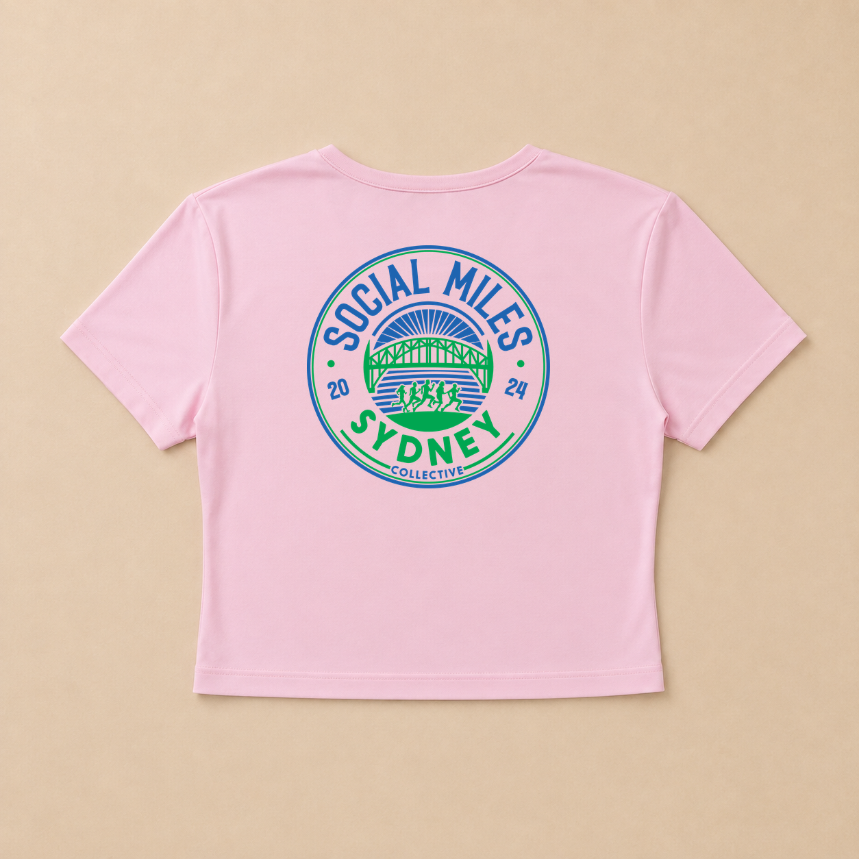 Back view of the pink cropped Social Miles Sydney tee with the large blue and green circular club crest.