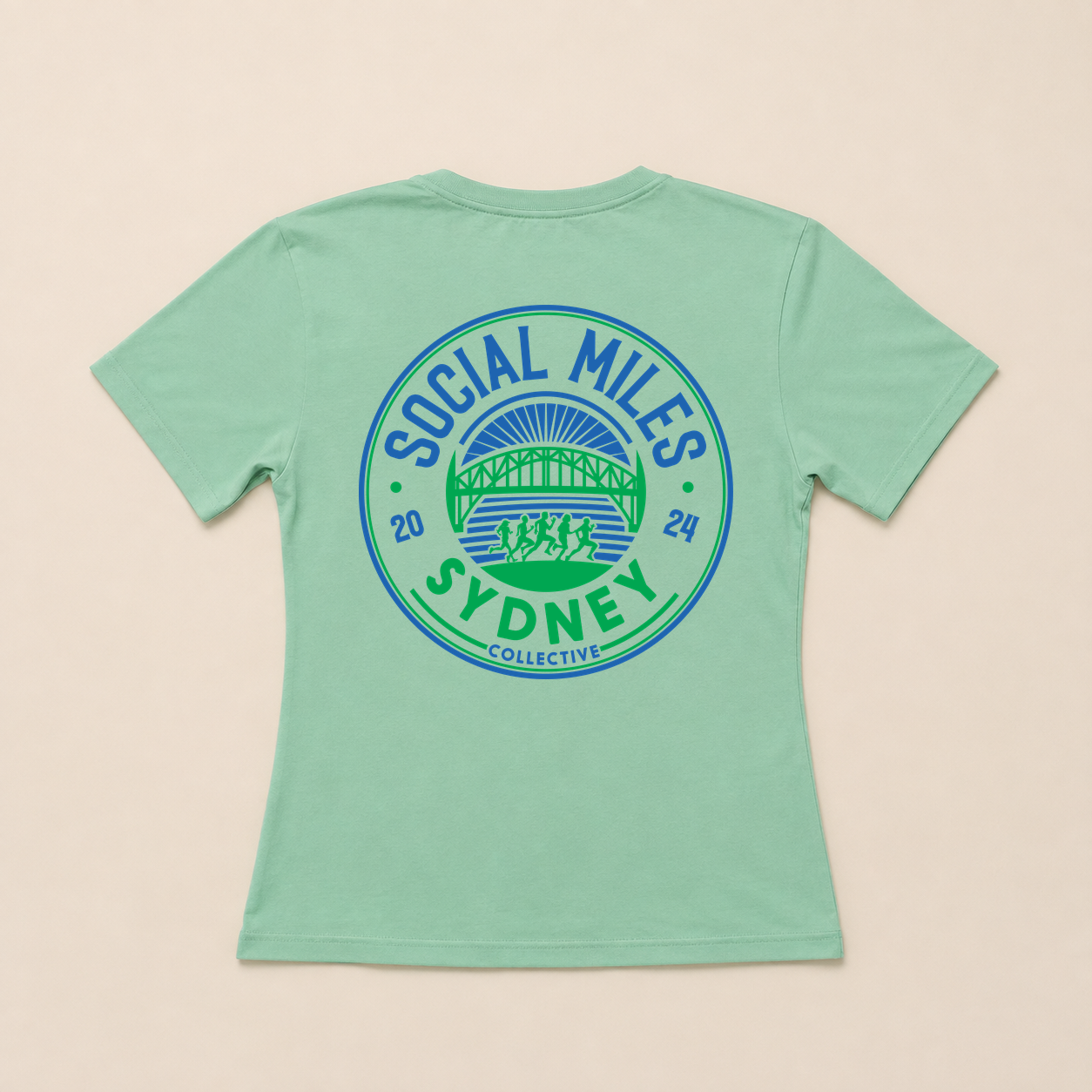 Back view of the mint Social Miles Sydney tee with the large blue and green circular Social Miles Sydney crest.