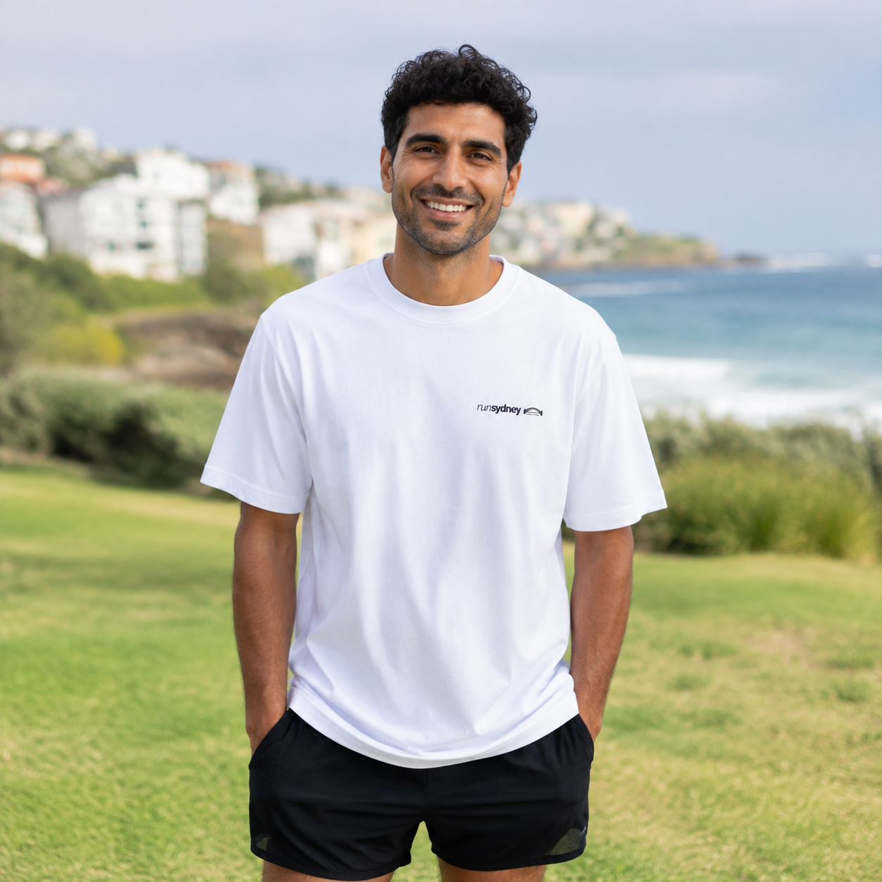 Member wearing the white runSydney oversized Social Miles Sydney tee, front view.